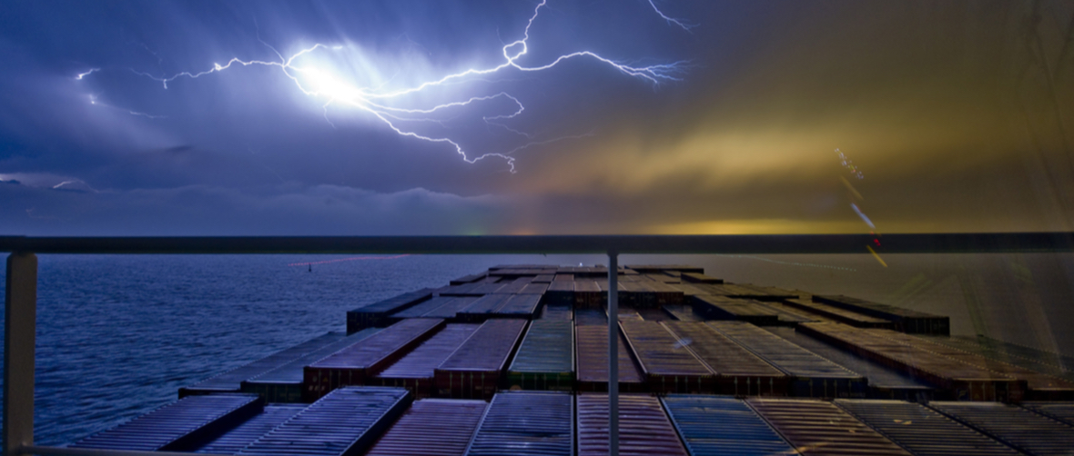 Lightning over the sea seen from the bridge of a container ship